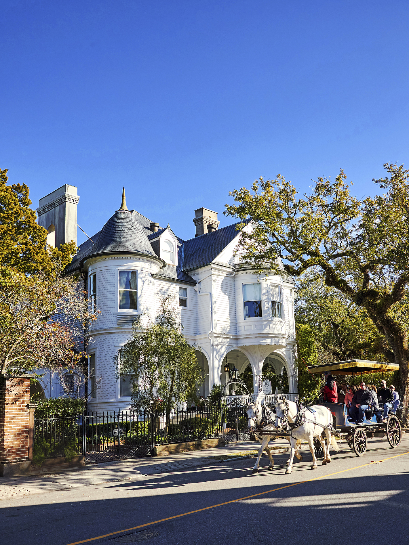 InPickleball | Horses and houses A carriage passing by the Two Meeting Street Inn. A room and pool area at Wild Dunes.
